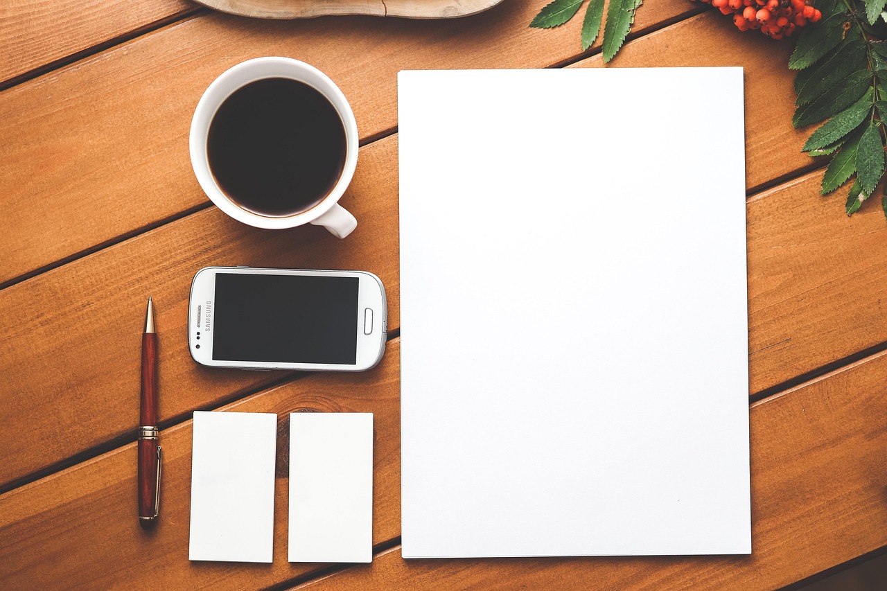 Coffee, phone, paper — Innovate and Immigrate: Navigating the Pathways of Canada's Startup Visa Program